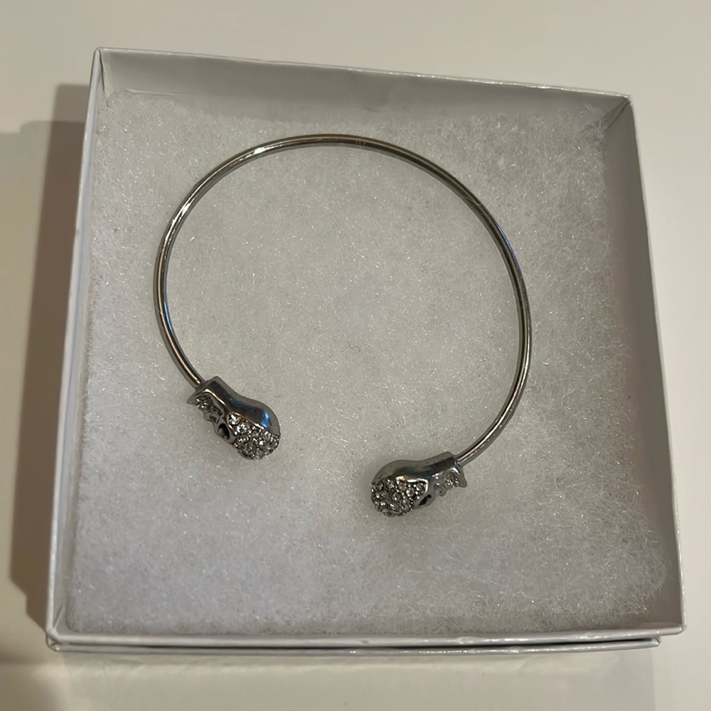 Double sided silver colored rhinestone skull bangle bracelet